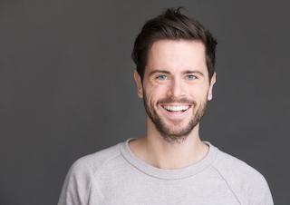 Man smiling at scaling and root planing dentist in Rockville, MD
