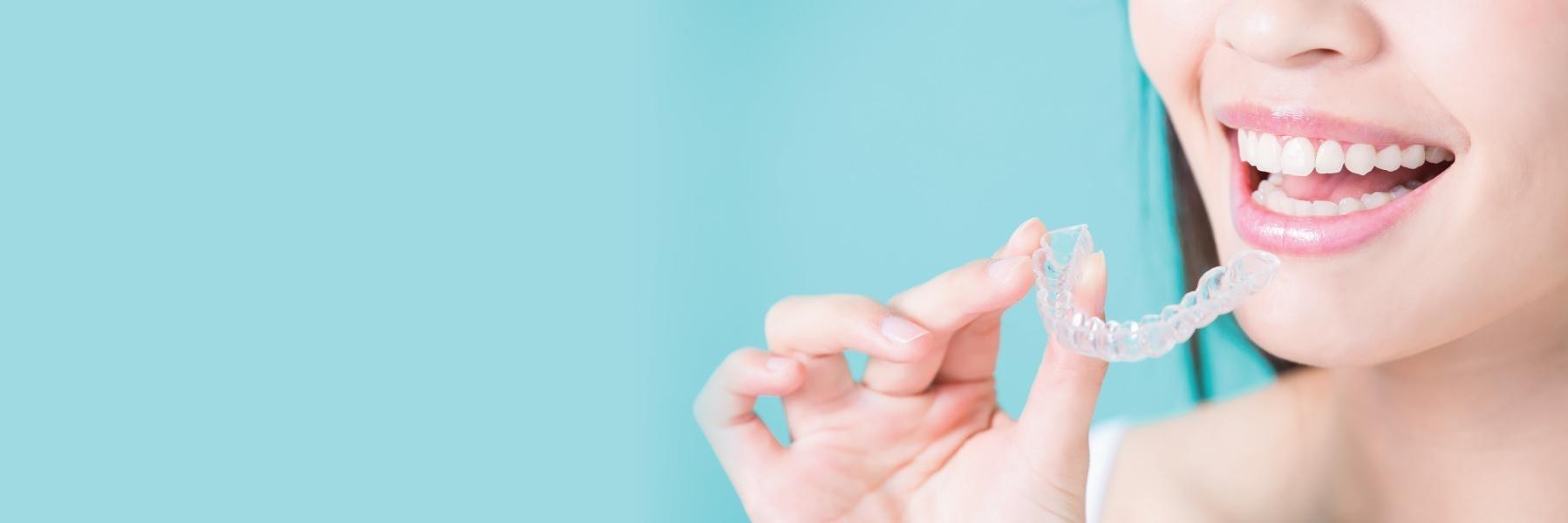 Woman holding tray of Invisalign aligners in Rockville, MD