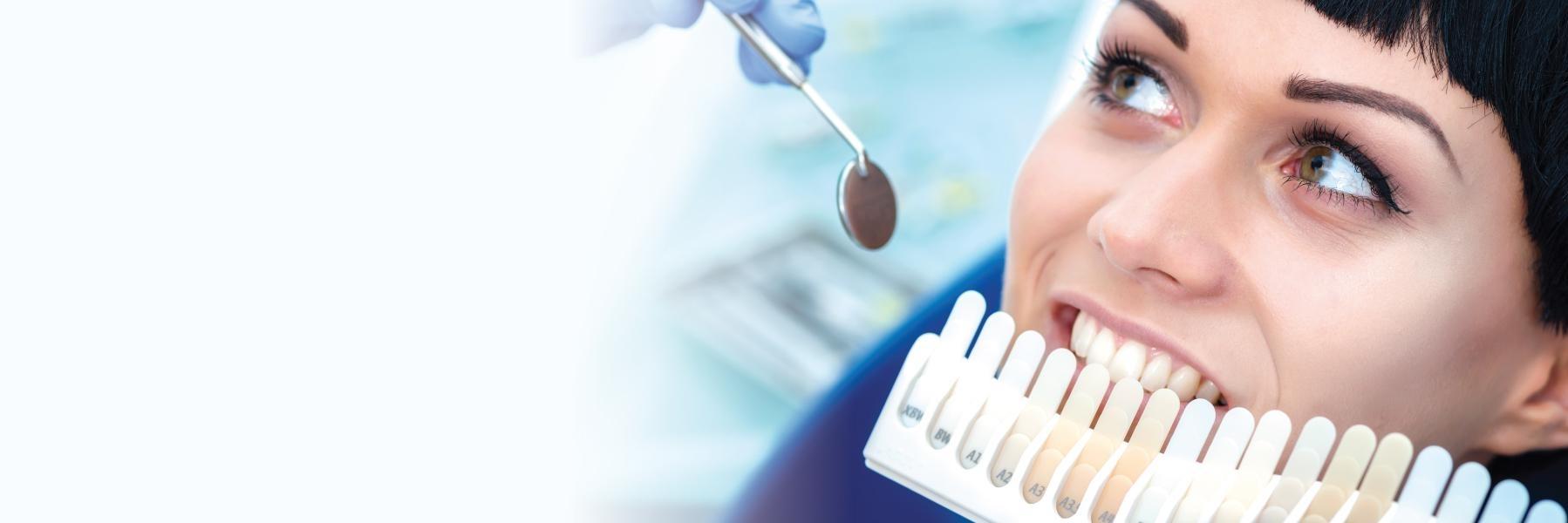 Woman testing shades of teeth whitening in Rockville, MD
