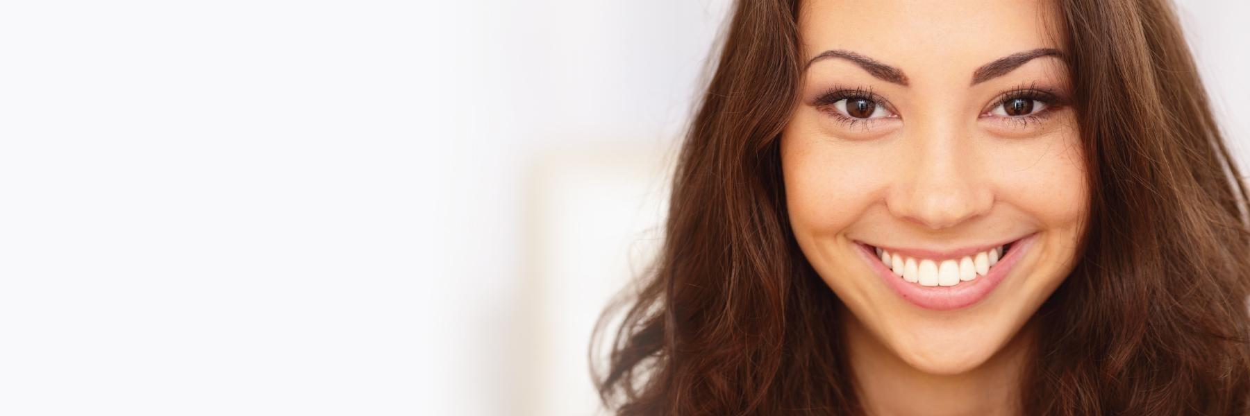 Woman with porcelain veneers smiling in Rockville, MD
